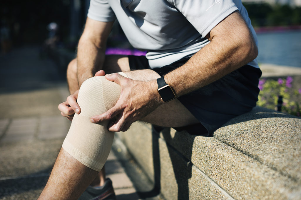 man suffering knee pain treatment
